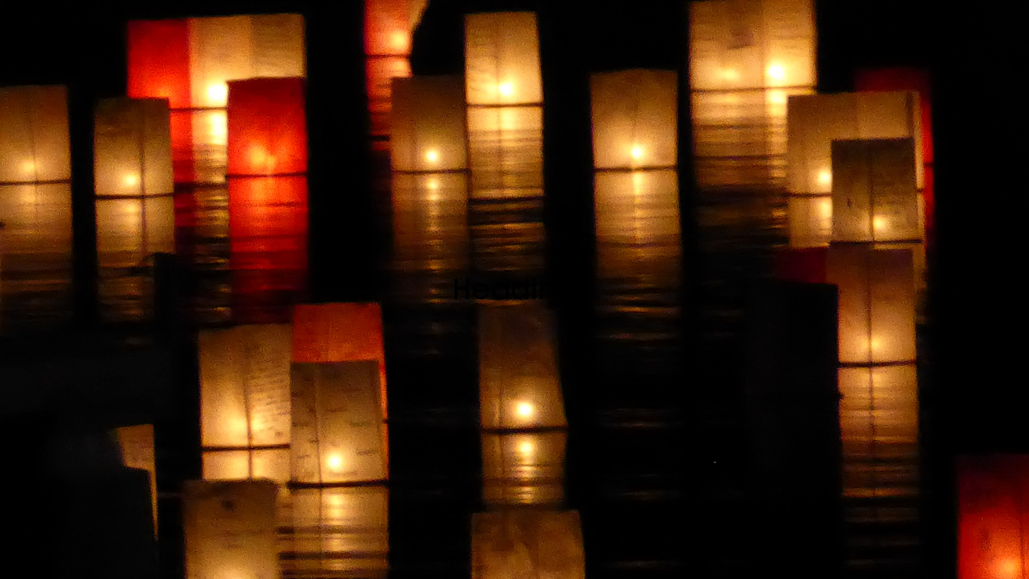 Lanterns float across the water.