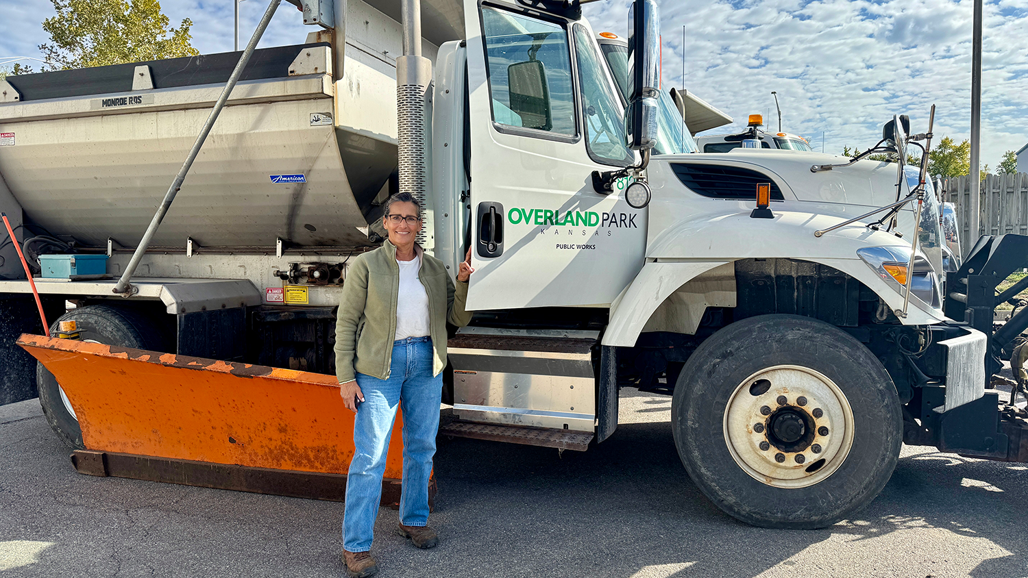 Snow plow driver Dianna Mahaney poses next to an Overland Park snow plow.